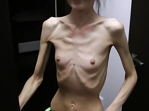 Half-starved Denisa posing collect close to up has ribs la-de-da